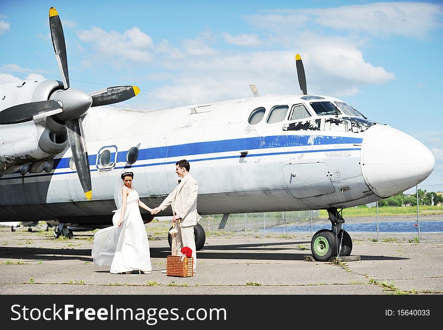 Groom and bride fly to wedding travel by  plane. Groom and bride fly to wedding travel by  plane