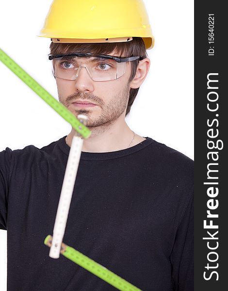 Portrait of construction worker with folding rule on white background