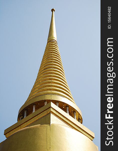 The peak of Golden Buddha Pagoda with details on the blue sky background