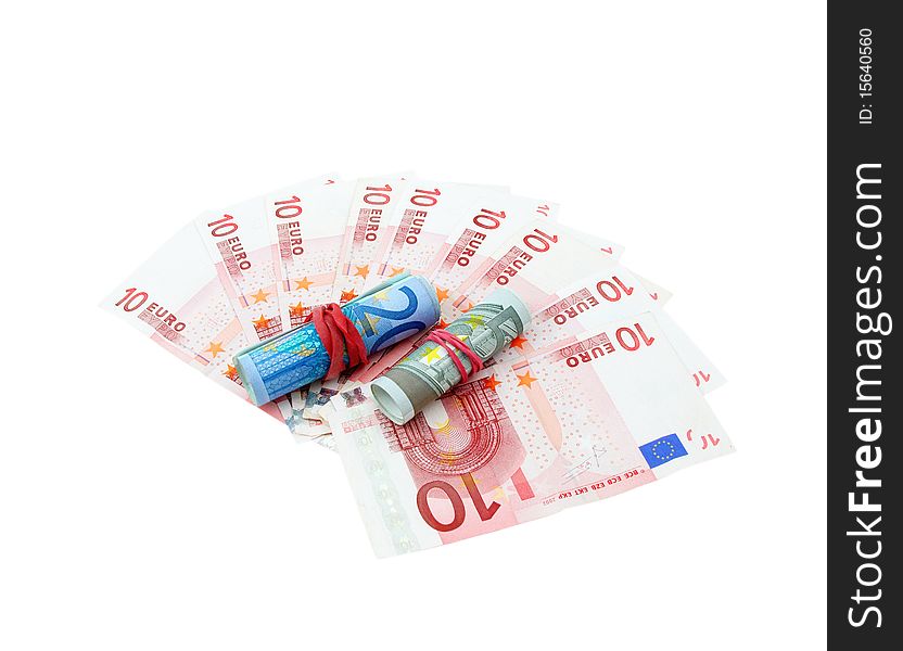 Ten euro banknotes fanned with five and twenty euro banknotes rolled on a white. Ten euro banknotes fanned with five and twenty euro banknotes rolled on a white