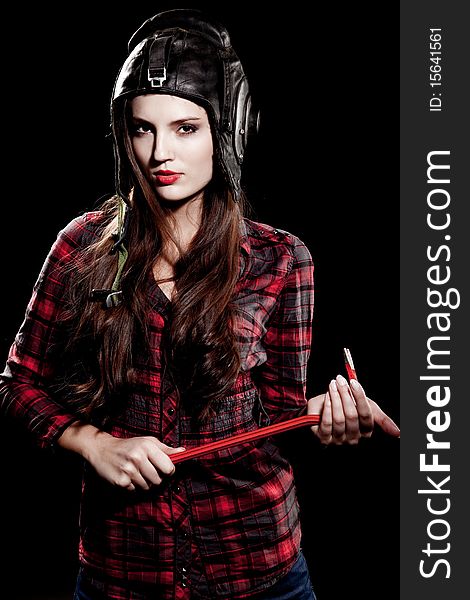 Young beautiful woman in cell shirt with red crowbar. Young beautiful woman in cell shirt with red crowbar