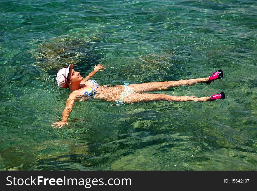 A girl floating in Adriatic waters of Montenegro. A girl floating in Adriatic waters of Montenegro
