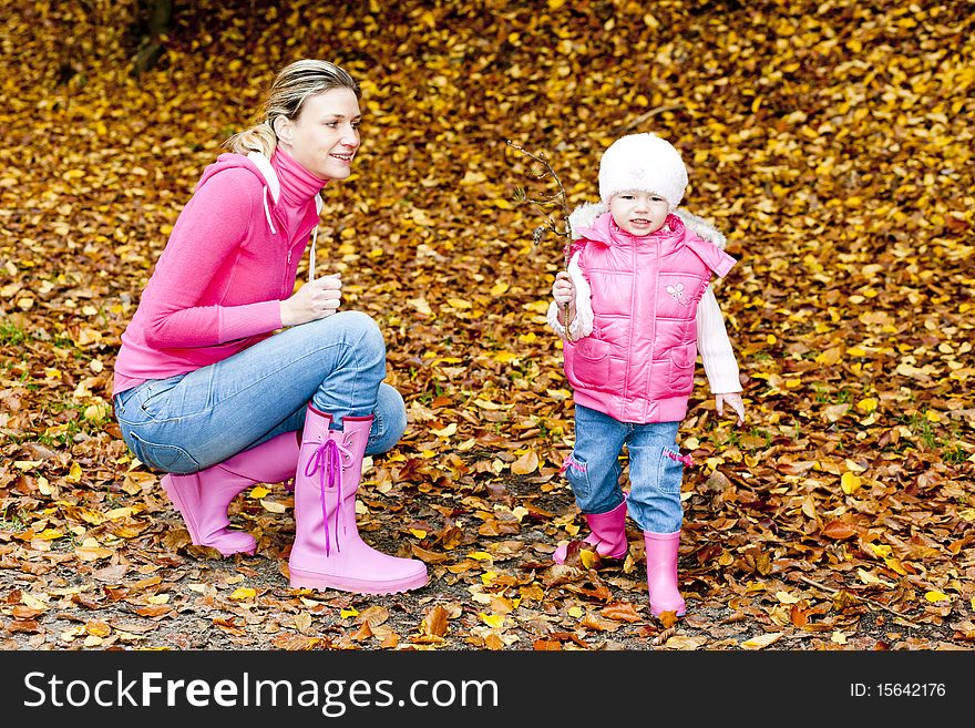 Mother with her daughter in autumnal nature