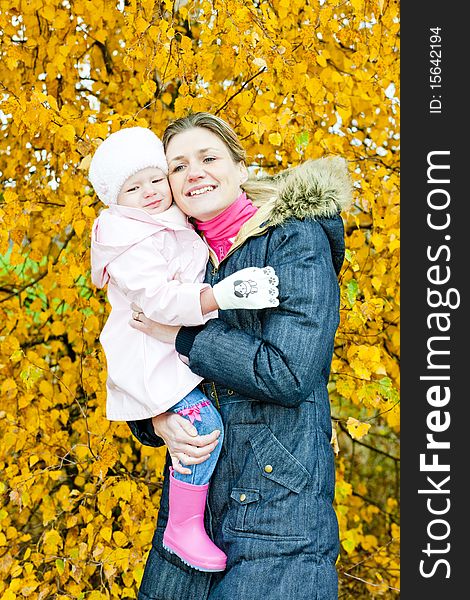 Portrait of woman with toddler in autumnal nature