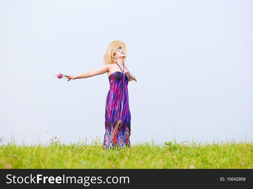 Young beautiful girl on a meadow