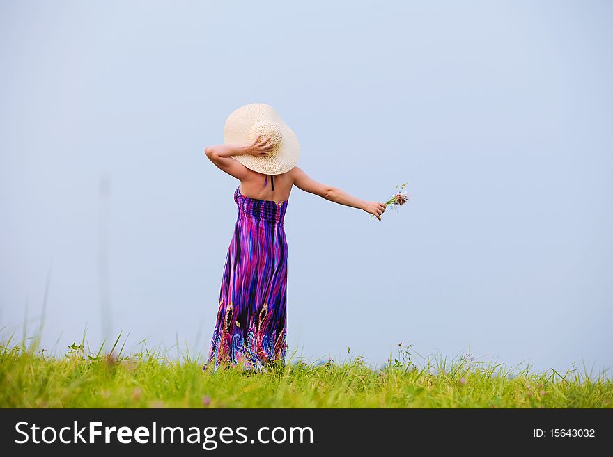 Young beautiful girl on a meadow