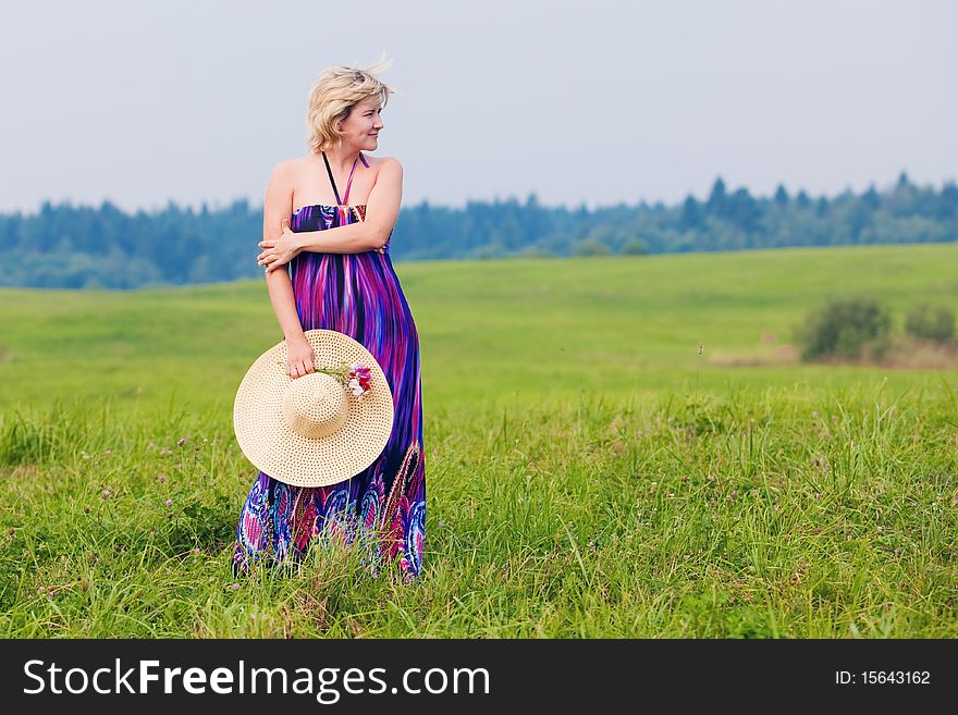 Young beautiful girl on a meadow