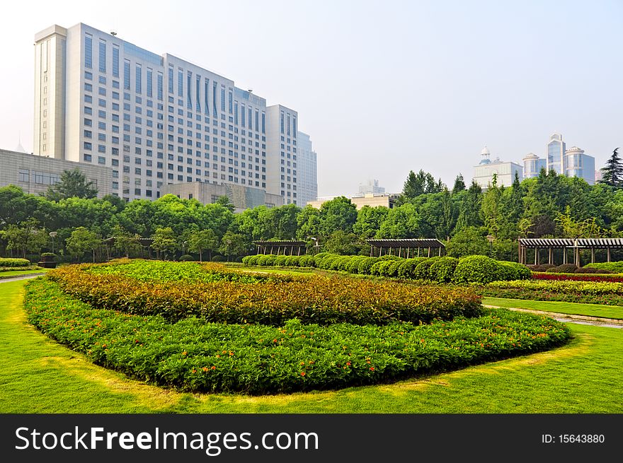 Beautiful garden surrounds a building in an urban area. Beautiful garden surrounds a building in an urban area