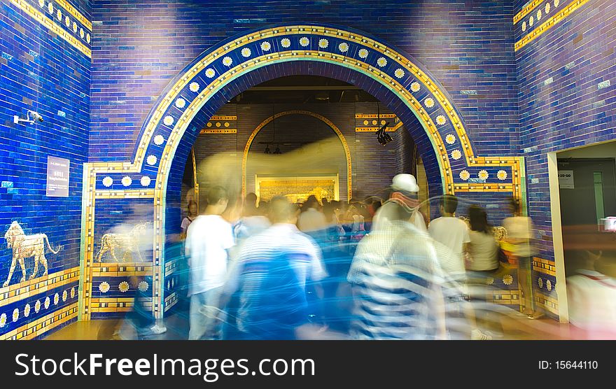 Blurred crowd through blue palatial arch of ancient rome