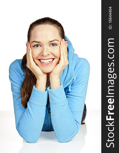 Beautiful portrait of a young attractive woman lying down smiling on the floor. Beautiful portrait of a young attractive woman lying down smiling on the floor