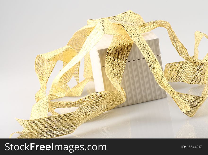 One gift box with gold ribbon isolated