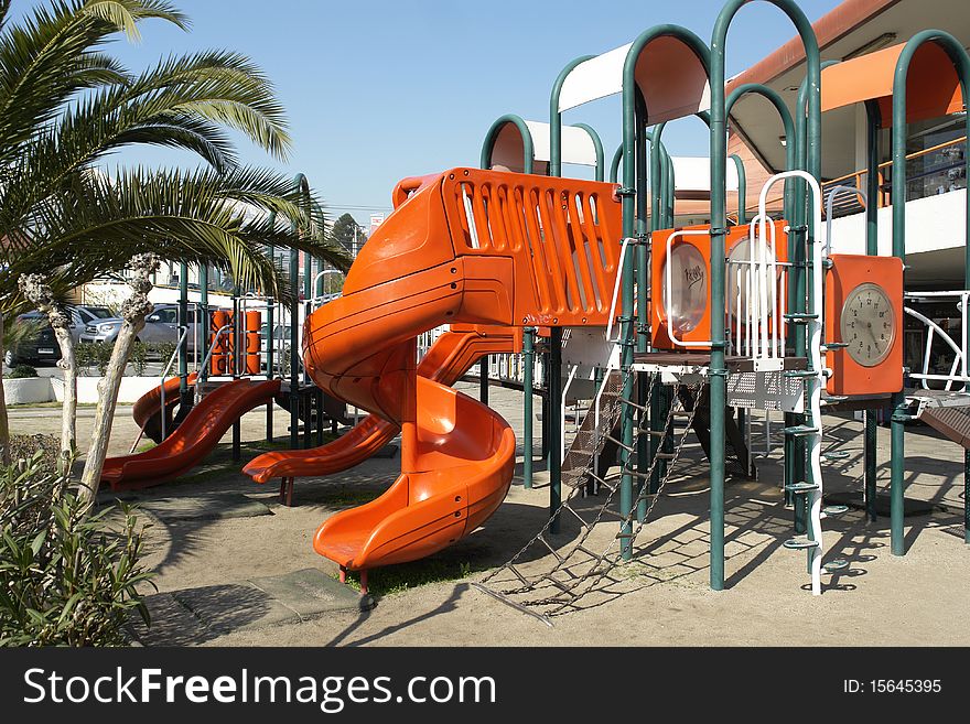 Public park with infantile games in commercial center. Public park with infantile games in commercial center