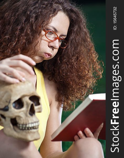 Young woman with concentration studies anatomy. Young woman with concentration studies anatomy