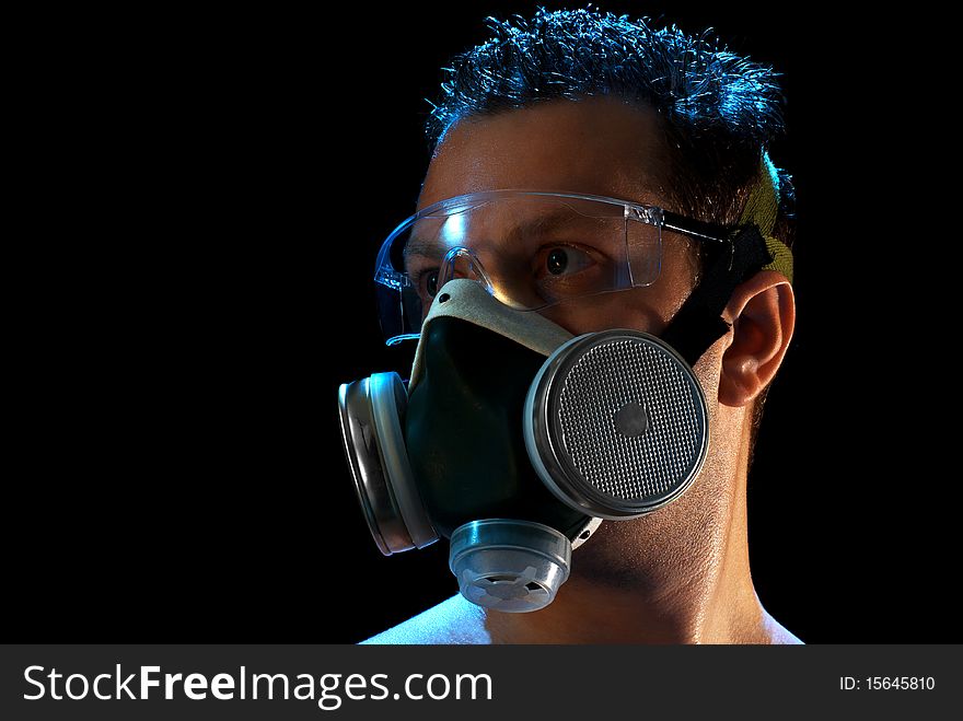 A man in a respirator and glasses suffering from smoke and heat in Moscow. Isolated on black. A man in a respirator and glasses suffering from smoke and heat in Moscow. Isolated on black.