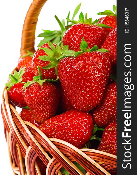 Ripe strawberry in wicker basketbasket isolated on a white background