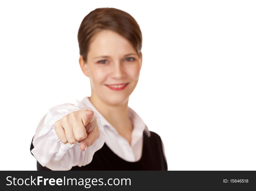 Cheerful business woman smiles and points with finger on camera. Isolated on white background.
