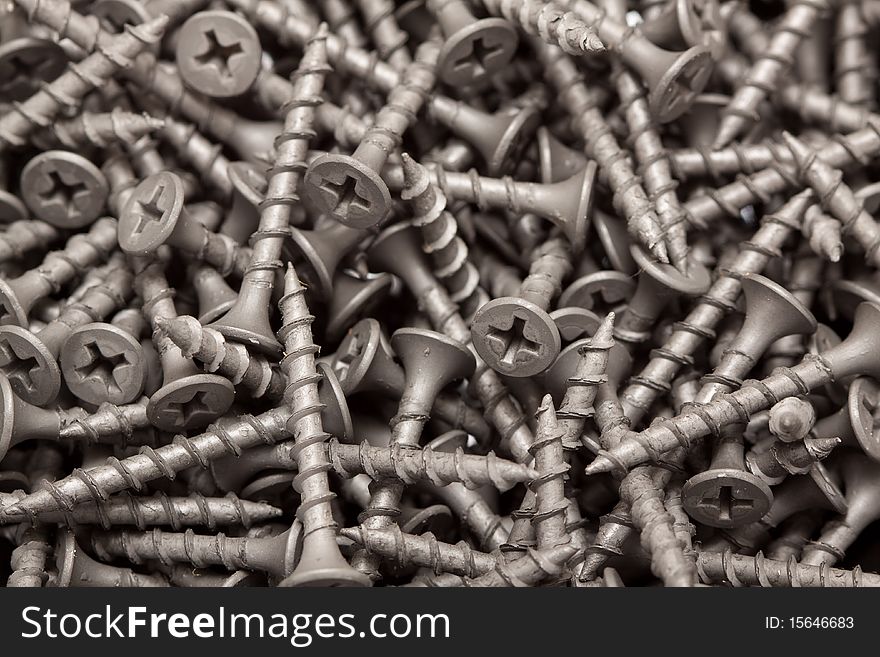 A macro shot of a heap of screws.