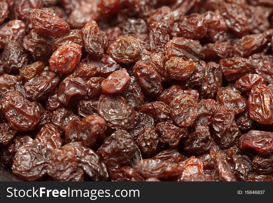 A macro shot of a heap of raisins.