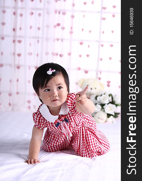 A portrati of a cute baby girl on white bed
