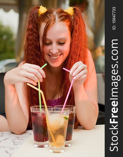 Girl with cocktails in cafe