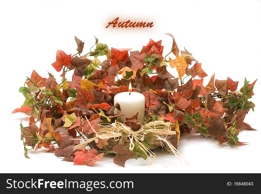 Autumn Candle and leaves on a white background
