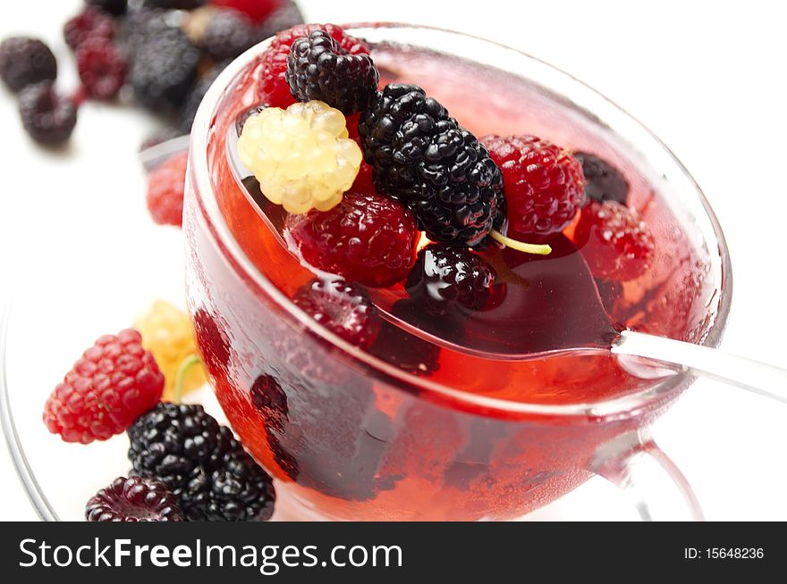 Ripe forest berries in the glass cup