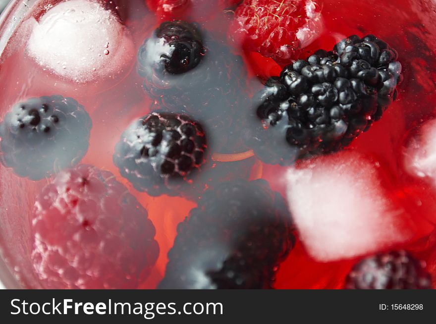 Ripe forest berries in the glass cup