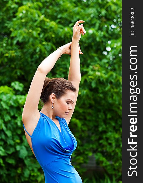 Attractive caucasian female posing in blue dress outdoors. Attractive caucasian female posing in blue dress outdoors