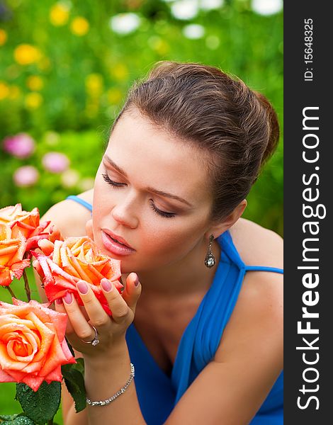 Attractive young adult with roses in the garden. Attractive young adult with roses in the garden