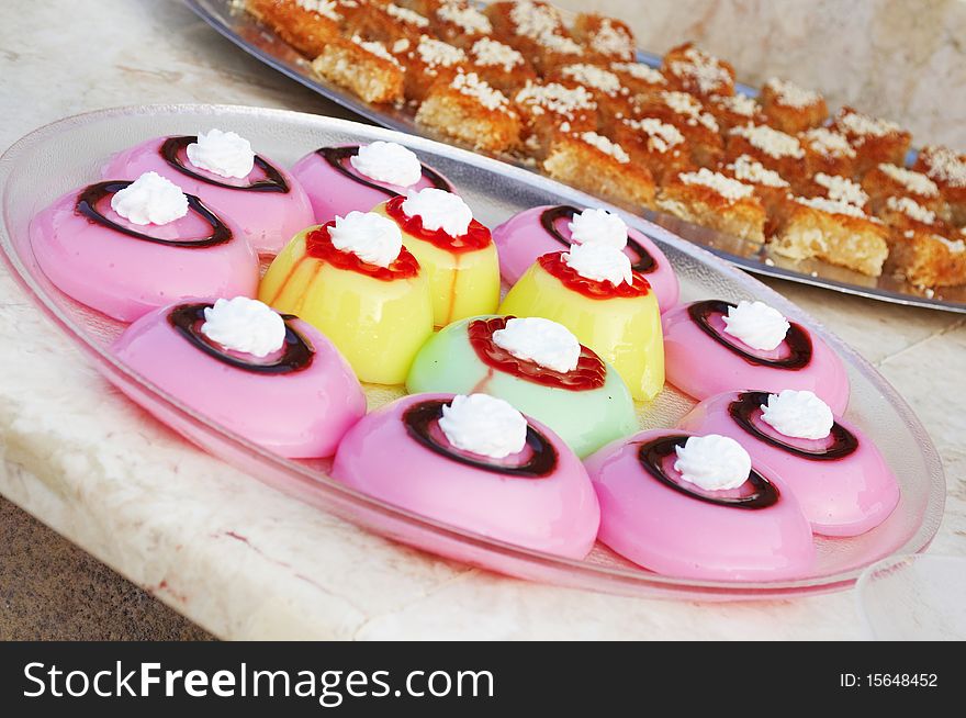 Colored jelly cakes with  chocolate and jam on the tops