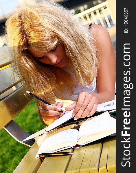 Young and beautiful girl doing school work