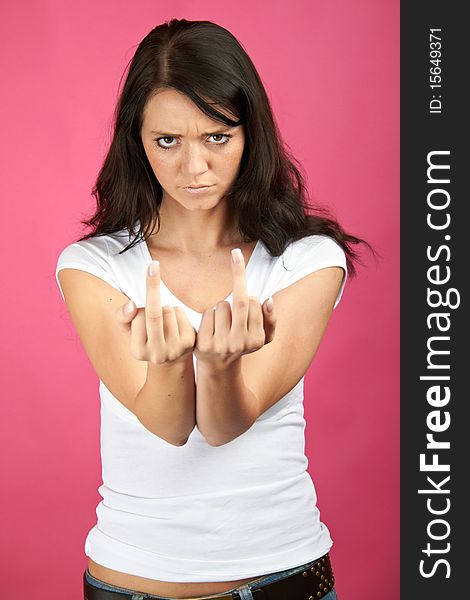 Portrait of a young angry woman is showing her middle-finger. Portrait of a young angry woman is showing her middle-finger