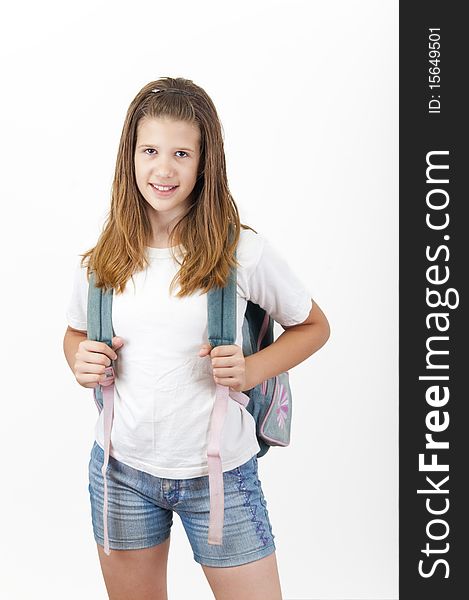 Young smiling girl with school bag on her back.