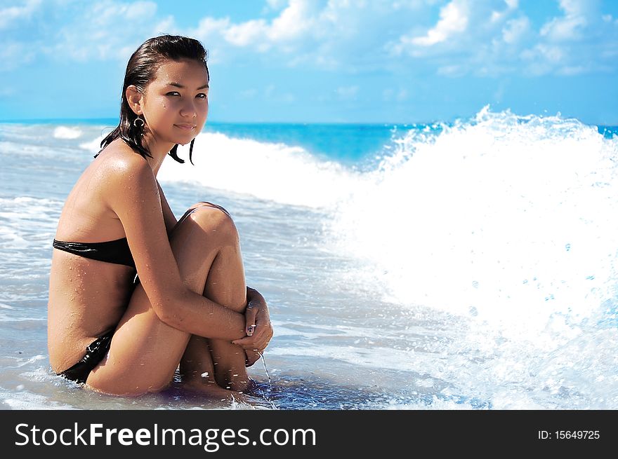 Blue sky, waves and beautiful girl on the beach