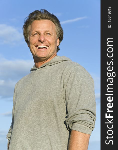 A colour portrait photo of a happy smiling man in his forties. A colour portrait photo of a happy smiling man in his forties.