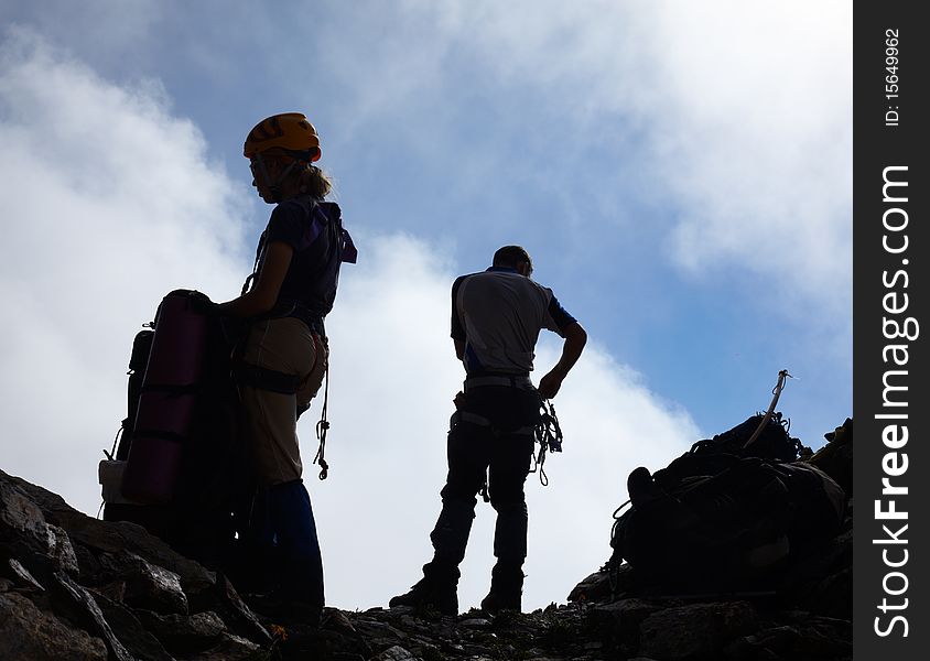 Couple of mountaneers on the top of mountain