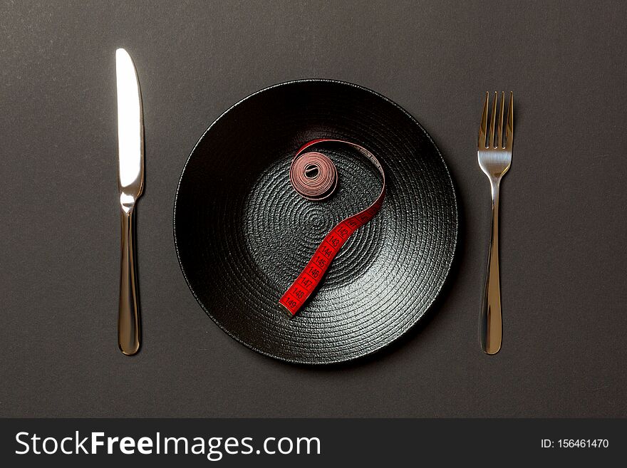 Fork And Plate With Measuring Tape On Color Background. Diet Concept