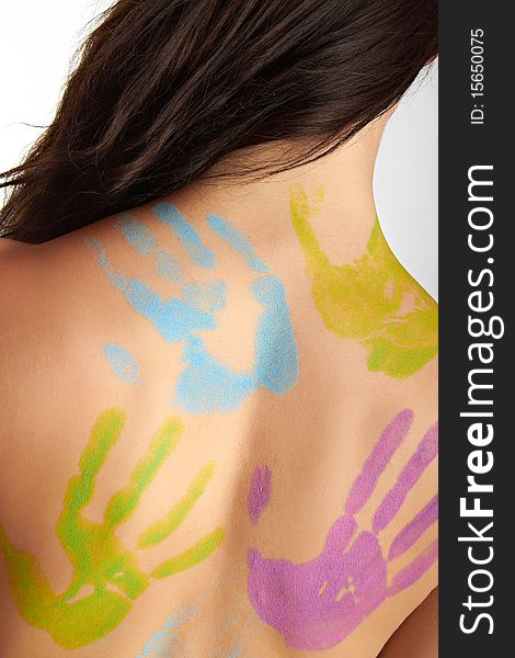The back of a young woman with bodypainting hands. The back of a young woman with bodypainting hands