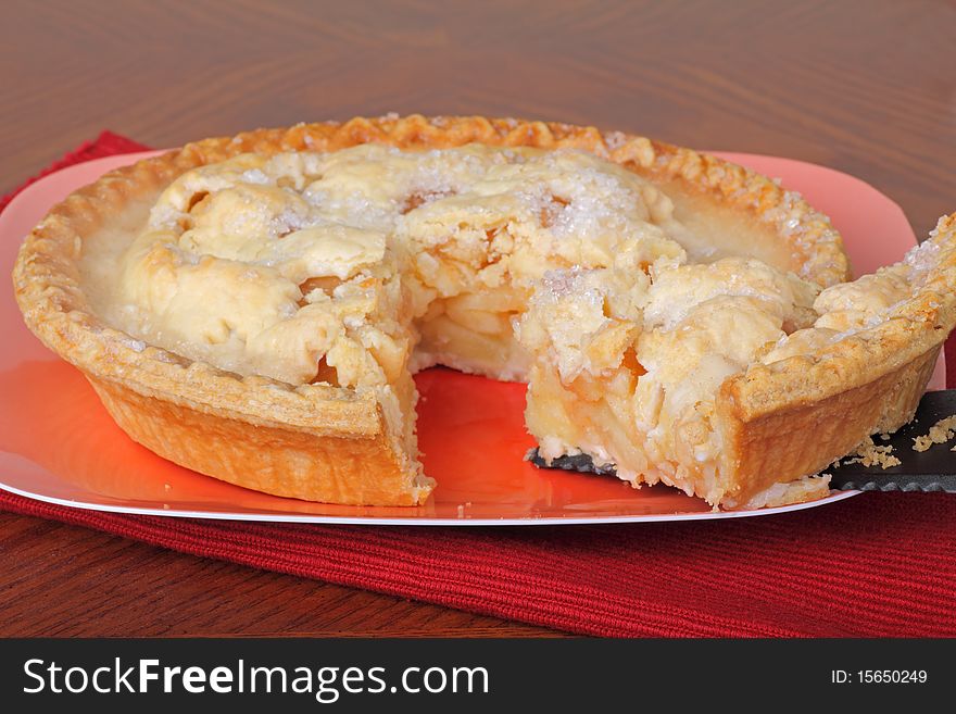 Slice of apple pie served from the whole pie. Slice of apple pie served from the whole pie