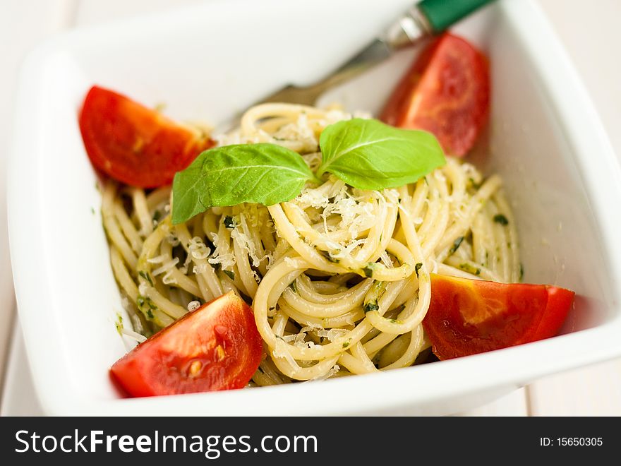 Spaghetti with pesto sauce and tomatoes. Spaghetti with pesto sauce and tomatoes