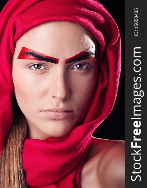Art make-up on the person young, beautiful, girls. Red eyebrows on the person of the young and beautiful girl