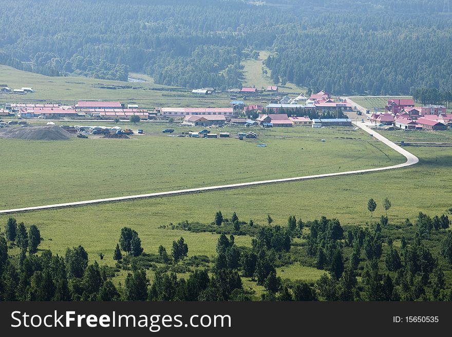 The rough concrete road in summer meadow of Inner Mongolia, China