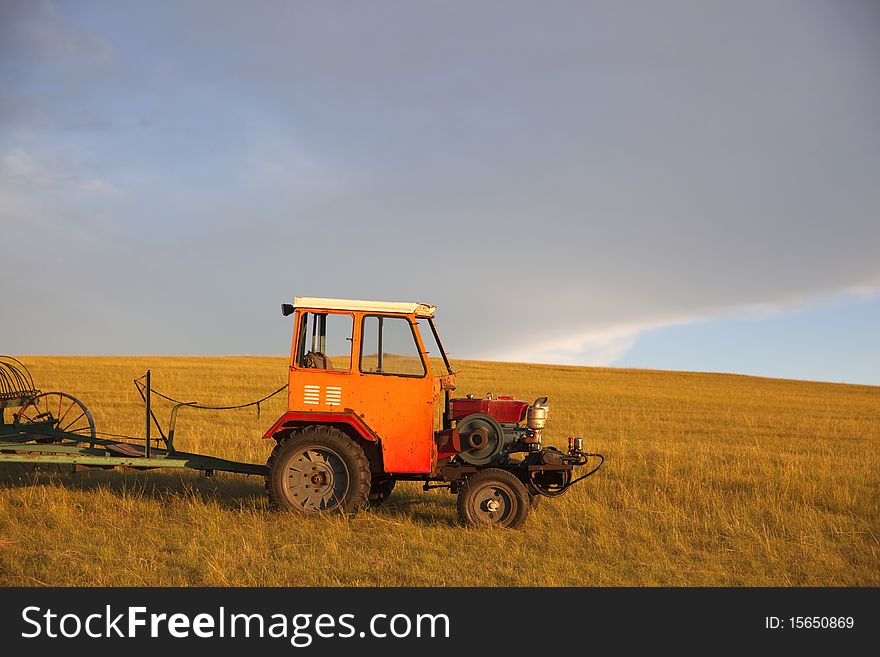 The agricultural machinery in summer prairies