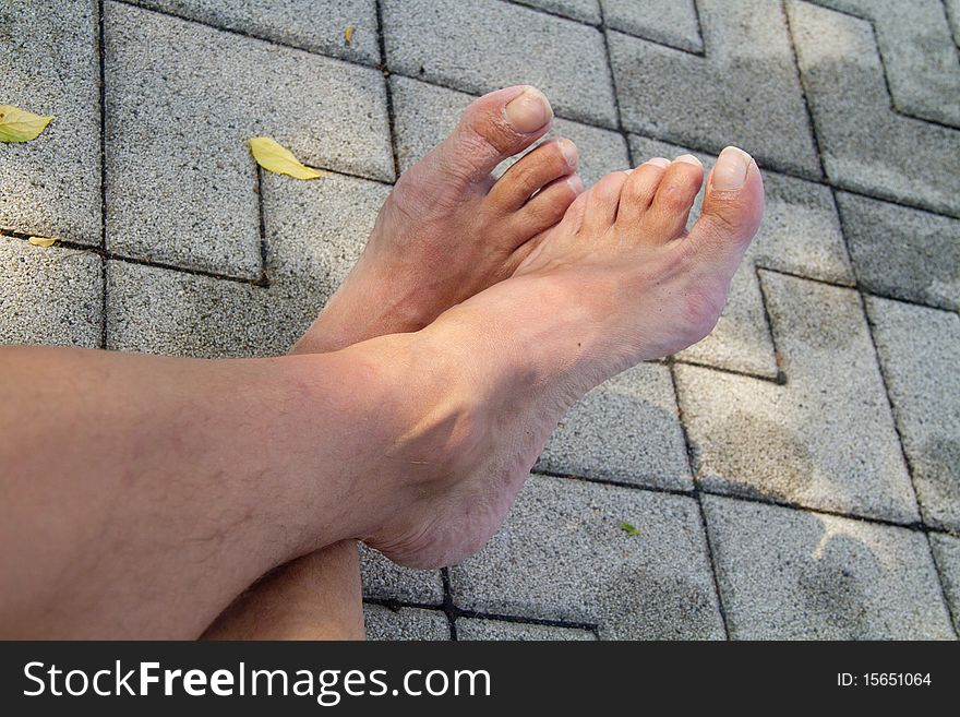 Barefoot on the tiles by the pool. Barefoot on the tiles by the pool