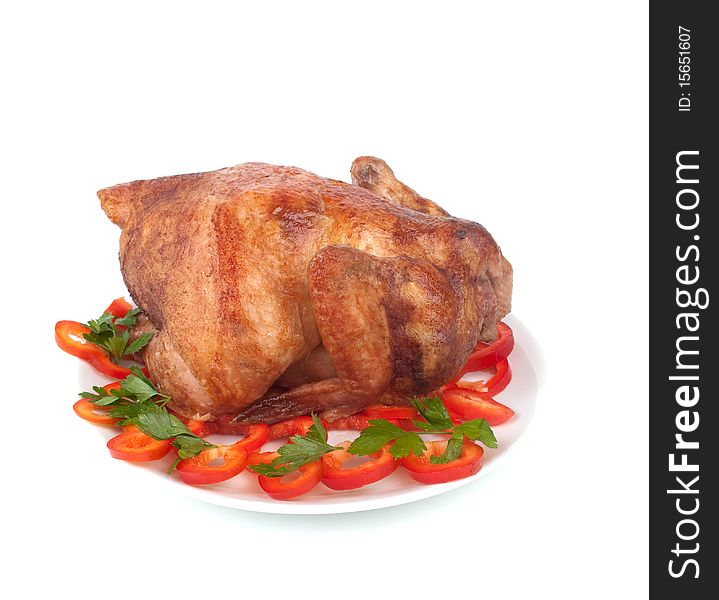 Baked hen on a plate on a white background