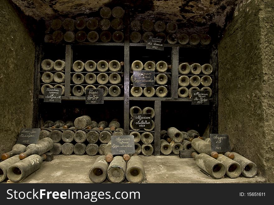 Vine cellar with old and dirty bottles