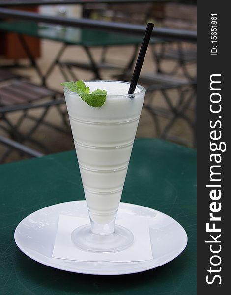 Glass of milk cocktail in street cafe