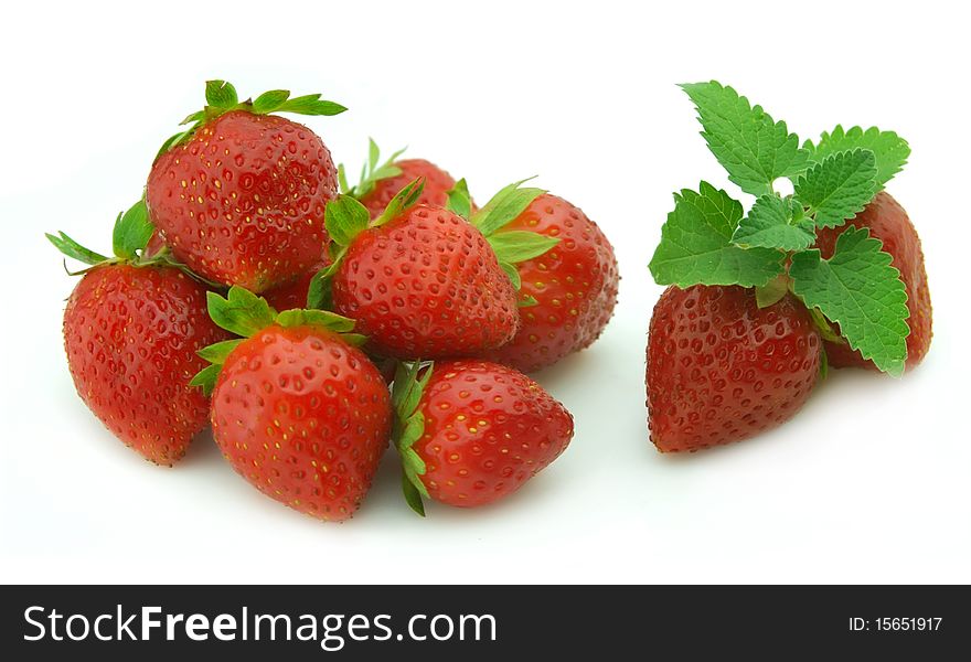 Ripe and juicy strawberry with mint on a white background