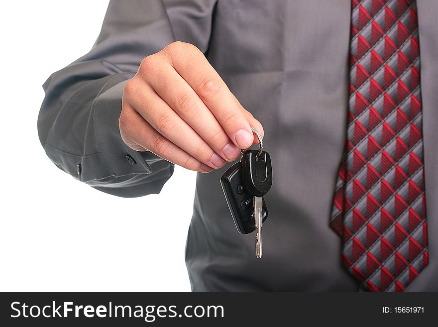 The businessman in a grey shirt and a tie stretches a car key. The businessman in a grey shirt and a tie stretches a car key.