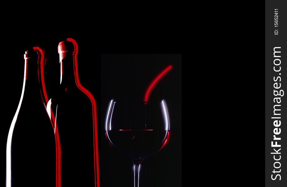 Montage of red wine glass and two bottles with black background